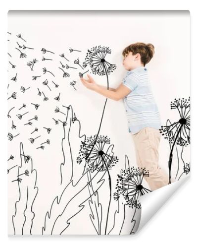 top view of kid blowing dandelion seeds while flying on white 