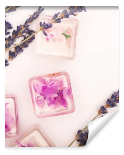 top view of frozen lavender flowers near twigs on white background