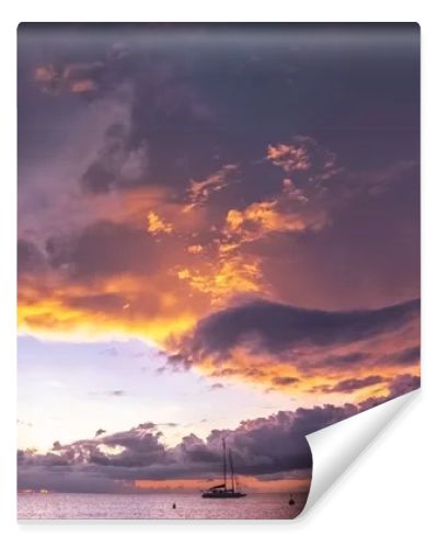 Panorama of beautiful sunset over ocean and sailboats