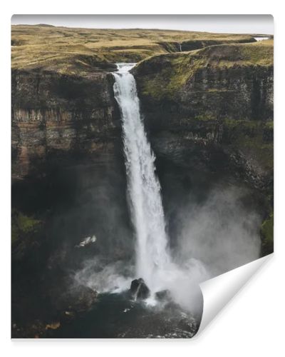 aerial view of icelandic landscape with Haifoss waterfall and green hills