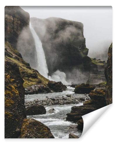 dramatic icelandic landscape with Haifoss waterfall on misty day