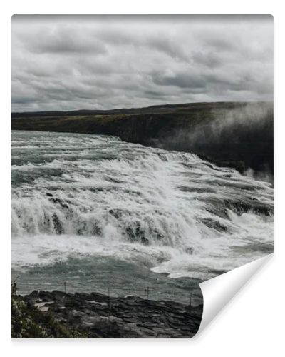 aerial view of beautiful Gullfoss waterfall under cloudy sky in Iceland