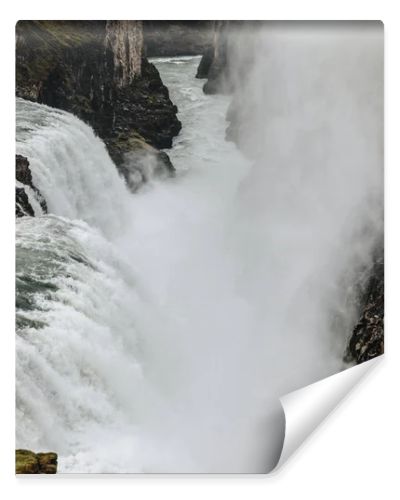 aerial view of steam above beautiful Gullfoss waterfall flowing through highlands in Iceland