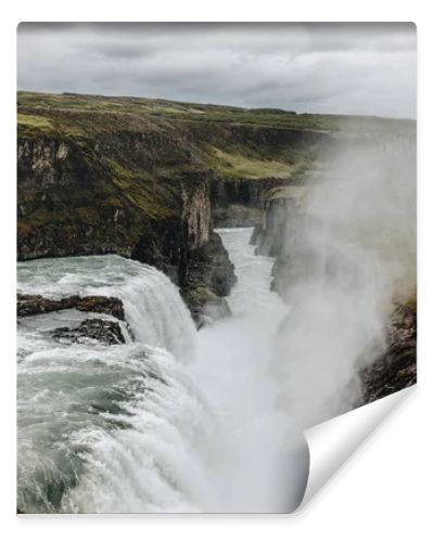 scenic view of steam above beautiful Gullfoss waterfall  flowing through highlands in Iceland