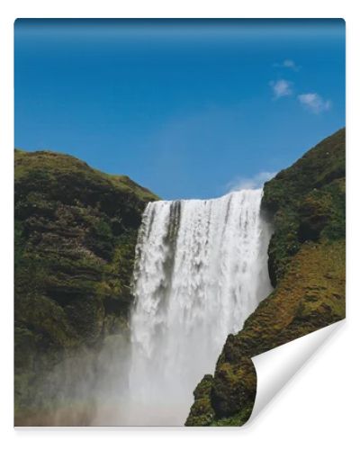 scenic view of waterfall Skogafoss against bright blue sky in Iceland