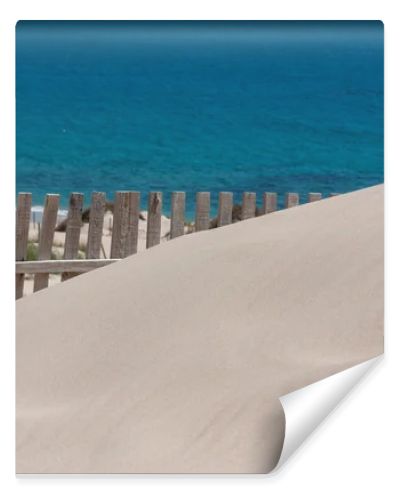 Wooden fences on deserted beach dunes in Tarifa, Spain