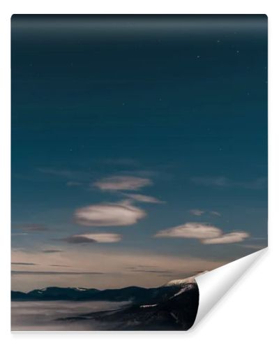 scenic view of snowy mountains with white fluffy clouds in evening