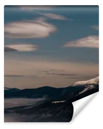 scenic view of snowy mountains with white fluffy clouds in evening, panoramic shot