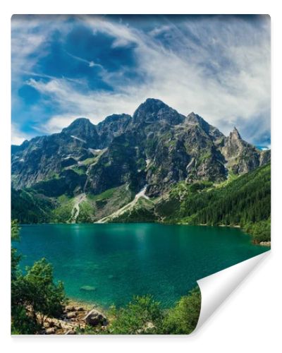 View on the turquoise color lake between high and rocky mountains. Beautiful alpine landscape. 