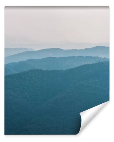 scenic and blue silhouette of mountains outside 