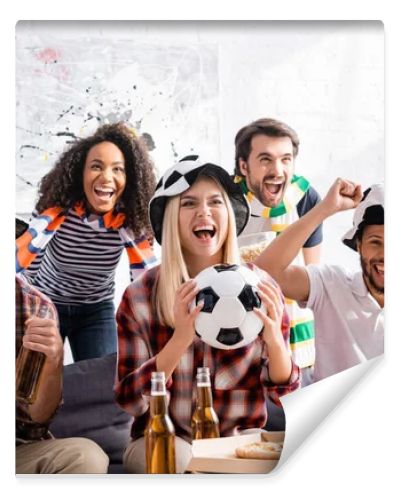 cheerful multicultural football fans shouting while watching championship at home