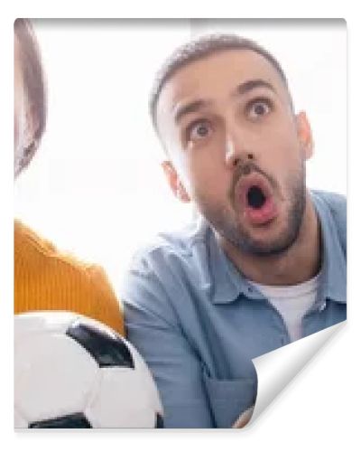 excited interracial father and son watching football championship at home, banner