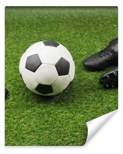 stopwatch with soccer ball and boots on grass