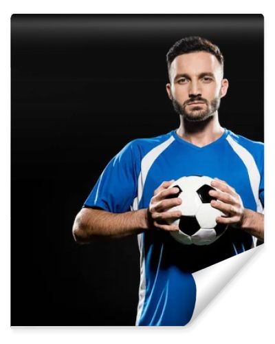 football player holding ball in hands isolated on black