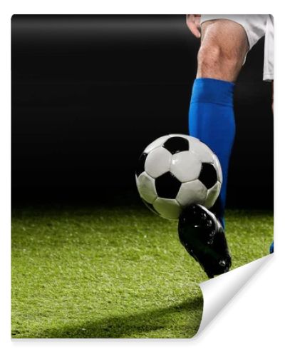 cropped view of man playing with ball on grass isolated on black