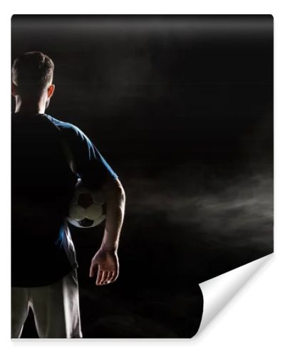 silhouette of man standing in uniform with ball on black with smoke  