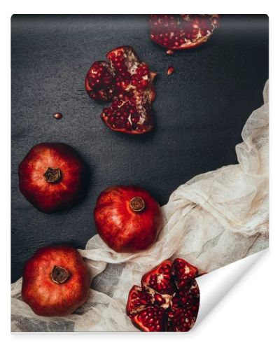 flat lay with gauze and fresh garnets arrangement on black tabletop