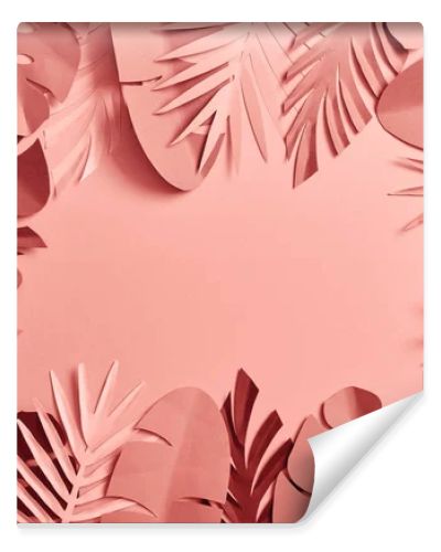 top view of tropical paper cut palm leaves on pink background