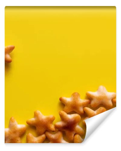 top view of tasty cookies in shape of stars on yellow