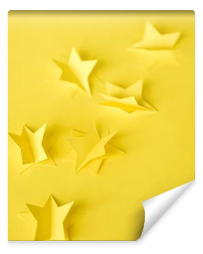 selective focus of paper stars on yellow 