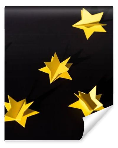 decorative yellow paper stars isolated on black 