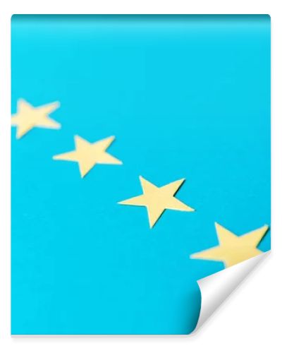 selective focus of yellow stars isolated on blue with copy space