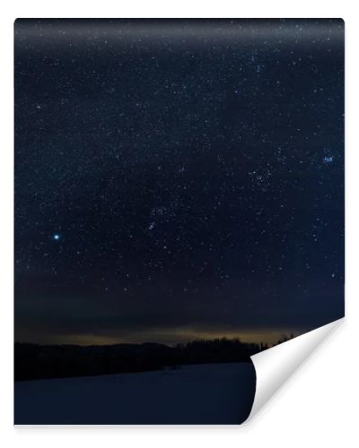 starry dark sky in carpathian mountains at night in winter