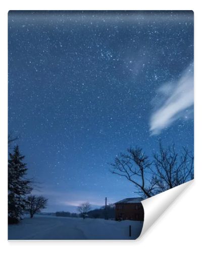 starry dark sky and house in carpathian mountains at night in winter