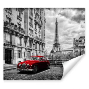 Artistic Paris, France. Eiffel Tower seen from the street with red retro limousine car.