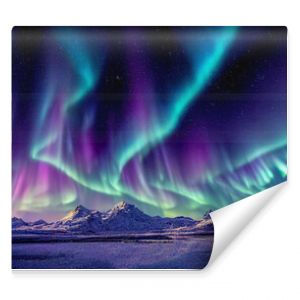 Aurora borealis on the Norway. Green northern lights above mountains. Night sky with polar lights. Night winter landscape with aurora and reflection on the water surface. Natural back