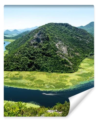 landscape of blue curved Crnojevica River and mountains in Montenegro