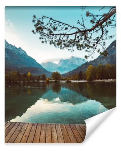 Jasna lake with beautiful reflections of the mountains and wooden pier. Triglav National Park, Slovenia