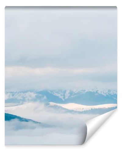 scenic view of snowy mountains in white fluffy clouds