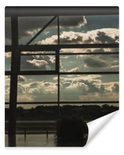 Panoramic orientation of windows in airport waiting hall with cloudy sky at background in Copenhagen, Denmark 