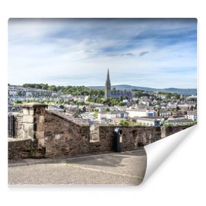 Londonderry, Northern Ireland: Skyline of Derry with St. Eugene's Cathedral near Free Derry Corner, city wall. horizon and blue sky