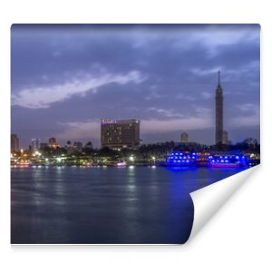 Panoramic view of Cairo city center at twilight, the Kasr El Nile Bridge and the island of Zamalek with its colorful boats on the Nile river.