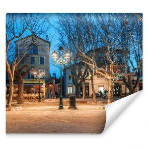 Beautiful night cityscape, tree illumination, lights and benches, central square Saint-Tropez, Provence, France