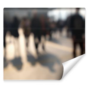 Blurred image of people dark silhouettes moving at city street. Art toning abstract urban background