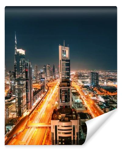 Night view of the spectacular landscape of Dubai with high-rises and skyscrapers at the Sheikh Zayed highway. Global travel destinations and real estate concept