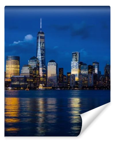 New York City Manhattan downtown skyline with skyscrapers illuminated over Hudson River panorama, including the One World Trade Center