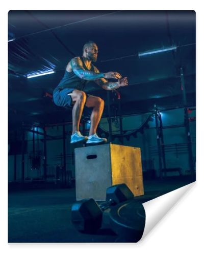 Young healthy man athlete doing exercise in the gym