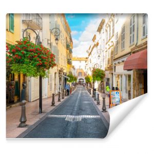 A picturesque street through the old town center of Antibes, France, in the Cote d'Azur, French Riviera region along the Mediterranean Sea.