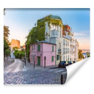 Cozy old street with pink house at the sunny sunrise, quarter Montmartre in Paris, France