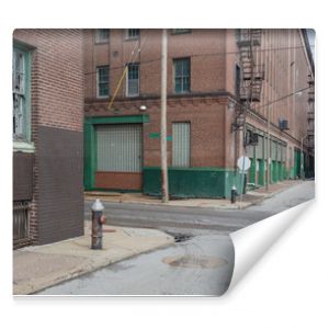 Vintage street scene with abandoned red brick warehouses in a depressed industrial area