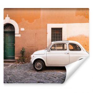 Vintage car parked in a cozy street in Trastevere, Rome, Italy, Europe.