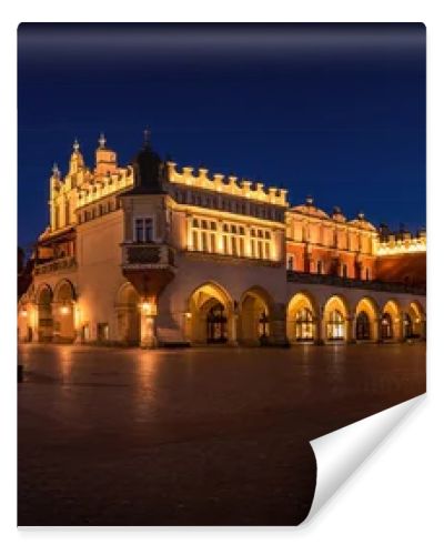 Cloth Hall Sukiennice building and main square of the old town illuminated at night on main square of Cracow. Poland  Panoramic view