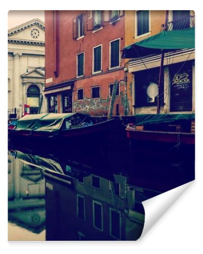 beautiful canal with boats in Venice