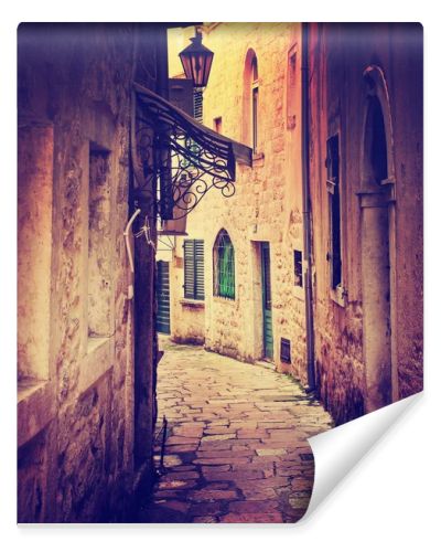 narrow street among old brick buildings in vintage colors