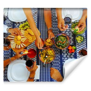 Male and female serving food on table during weekend