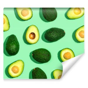 Fresh avocado pattern on a green background flat lay